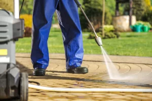 Worker and pressure washer